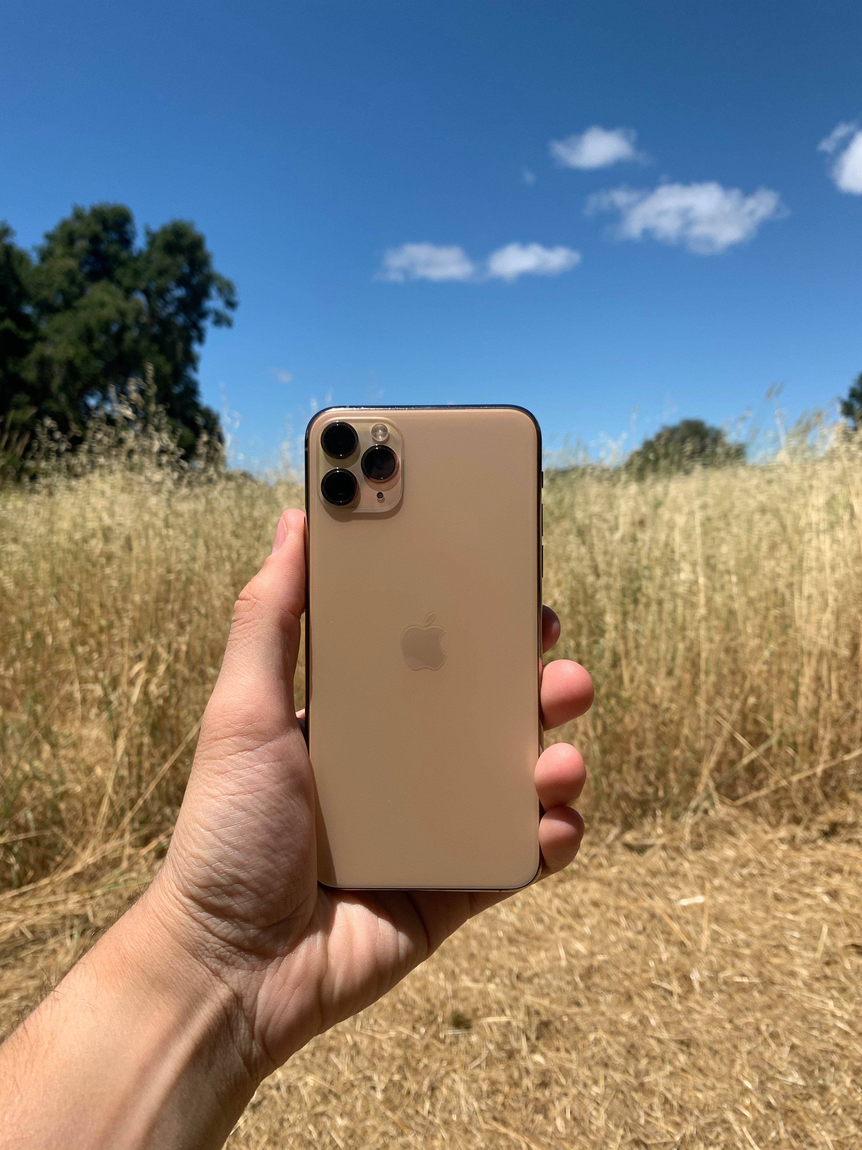 person holding white smartphone with green case